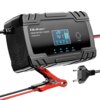Czarna inteligentna ładowarka z wyświetlaczem LCD, na którym widoczne są ikony i cyfry, oraz napisem "Qoltec SMART BATTERY CHARGER 12V 8A/24V 4A". Ładowarka posiada czerwony zacisk i wtyczkę elektryczną, a na obudowie znajdują się przyciski oznaczone jako