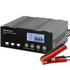Czarna inteligentna ładowarka z wyświetlaczem LCD pokazującym parametry ładowania, z przyciskami oznaczonymi jako "CHARGING", "24V", "12V", "12.6V LITHIUM", "ORDINARY", "AGM", "REPAIR" oraz logo "Qoltec SMART BATTERY CHARGER 12V/24V". Obok ładowarki znajd
