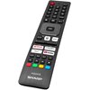 Na zdjęciu znajduje się telewizor wyświetlający ekran główny z aplikacjami takimi jak Netflix, YouTube, Disney+, Prime Video, Player, Polsat Box Go, HBO Max, TVP VOD, CDA Premium i Plex. Na ekranie widoczny jest także tytuł "The Pillagers" oraz lista popu