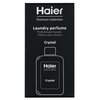 Czarne opakowanie z białym napisem "Haier Premium Collection" oraz "Laundry perfume" w kilku językach, z graficznym konturem butelki i napisem "Crystal".