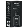 Czarne opakowanie z białymi napisami zawiera tekst: "Haier Premium Collection, Laundry perfume, Profumo per bucato, Parfum pour lessive, Crystal". Na opakowaniu widoczny jest zarys butelki oraz logo "Haier".