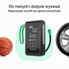 Urządzenie rozruchowe z wyświetlaczem pokazującym 0.0 oraz 10.30 BAR, z widocznym logo "GREEN CELL" i przyciskami sterującymi, obok piłki i opony. Tekst na górze: "Do małych i dużych wyzwań. Napompuje od piłki po oponę samochodu".