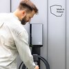 Na zdjęciu widoczna jest ładowarka do samochodu elektrycznego z logo "GC" na obudowie, zamontowana na ścianie, z podłączonym kablem. Obok ładowarki znajduje się napis "Made in Poland".