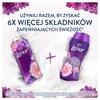 Na zdjęciu znajdują się dwa fioletowe opakowania produktów marki Lenor z kwiatowymi wzorami, obok siebie na białym tle, z napisem: "Używaj razem, by zyskać 6x więcej składników zapewniających świeżość*". Na dole widoczna jest informacja: "*Składniki zapew