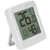Biały termometr cyfrowy z wyświetlaczem pokazującym temperaturę 26°C oraz wilgotność 48% RH, z uśmiechniętą buźką poniżej. Urządzenie ma prostokątną obudowę i jest ustawione na rozkładanej podstawce.