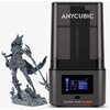 Drukarka 3D z przezroczystą obudową, na której widnieje napis "ANYCUBIC", stoi obok szczegółowego, szarego modelu postaci. Na dolnej części drukarki znajduje się ekran z interfejsem użytkownika oraz napis "PHOTON MONO 4 ULTRA".