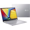 Srebrny laptop z otwartym ekranem, na którym widnieje kolorowa grafika z napisem "ASUS Vivobook". Obok znajduje się zamknięta pokrywa laptopa z logo "ASUS Vivobook" i napisem "ASUS Vivobook" na etykiecie.