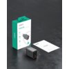 Na zdjęciu znajduje się szara ładowarka sieciowa z widocznym logo AUKEY oraz opakowanie z napisem "AUKEY Comet 45W PD Wall Charger with GaN Technology". Obok leży instrukcja użytkownika z napisem "AUKEY USER MANUAL".