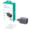 Pudełko z napisem "AUKEY Comet Mix 3 67W PD Wall Charger with GaN Technology" oraz szara ładowarka z widocznymi oznaczeniami "67W" i "AUKEY". Obok znajduje się instrukcja użytkownika z napisem "AUKEY USER MANUAL Comet Mix 3 67W".