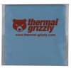 Kwadratowy, niebieski termopad z czerwonym logo i napisem "thermal grizzly" oraz adresem strony internetowej "www.thermal-grizzly.com" na powierzchni. Produkt ma delikatną, siatkową fakturę.