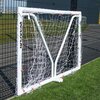 Bramka do piłki nożnej o białej konstrukcji z siatką, ustawiona na trawie przed metalowym ogrodzeniem. Na pionowym słupku widoczny jest napis "QUICKPLAY".