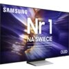 Telewizor z wyświetlaczem prezentującym abstrakcyjne, kolorowe wzory w odcieniach fioletu i złota, z widocznym logo "SAMSUNG" oraz dużym napisem "Nr 1 NA ŚWIECIE". Na dole znajduje się mniejszy tekst: "Najczęściej kupowane telewizory od 19 lat" oraz oznac