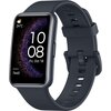 Na zdjęciu widoczny jest czarny smartwatch z prostokątnym wyświetlaczem, na którym pokazana jest godzina 10:08, data "Fri, Oct 18", liczba kroków "7645" oraz temperatura "24°C" z ikoną pogody. Pasek zegarka jest wykonany z ciemnego materiału, a na ekranie