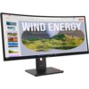 Zakrzywiony monitor wyświetla prezentację z dużym napisem "WIND ENERGY" oraz obrazem zielonych wzgórz i miasta w tle. Na ekranie widoczne są także miniatury slajdów po lewej stronie oraz pasek zadań systemu operacyjnego u dołu, a na podstawie monitora znajduje się logo "Lenovo".