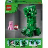 Opakowanie zestawu LEGO przedstawia dużą figurkę Creepera z gry Minecraft, zbudowaną z zielonych klocków, obok której znajduje się różowa świnka i blok TNT z napisem "TNT". Na górze opakowania widnieje logo LEGO oraz numer zestawu 21276, a na dole znajduj