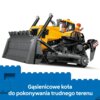 Na zdjęciu znajduje się żółty buldożer z klocków LEGO z gąsienicami i dużą łyżką z przodu, a w kabinie siedzą dwie figurki w kaskach. Na dole zdjęcia widnieje napis: "Gąsienicowe koła do pokonywania trudnego terenu".