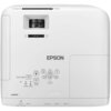 Biały projektor z widocznym logo "EPSON" oraz przyciskami sterującymi, takimi jak Home, Menu, H/V, Esc, a także oznaczeniami złączy: USB-A, USB-B, Audio Out, HDMI 1, HDMI 2. Na obudowie znajdują się również wskaźniki statusu, lampy i temperatury oraz pokr