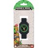Opakowanie przedstawia zegarek z motywem popularnej gry, z czarnym paskiem i tarczą ozdobioną zielonymi elementami oraz cyframi. Na opakowaniu widnieje logo "Minecraft" oraz napis "Time Teacher Watch" w trzech językach, a także oznaczenie wiekowe 6+.
