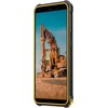 Obraz przedstawia smartfon z pomarańczową obudową, na ekranie którego widoczna jest koparka na tle nieba. Na zdjęciu umieszczono wymiary urządzenia: 7,68 cm szerokości, 15,17 cm wysokości, 5,45" (13,84 cm) przekątnej ekranu oraz 14,34 mm grubości.