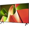 Tył telewizora z widocznym napisem "LG OLED" na środku obudowy. Na dolnej części znajdują się złącza i etykiety z informacjami technicznymi, w tym logo "HDMI" oraz specyfikacje dotyczące zasilania i połączeń.