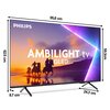 Telewizor marki PHILIPS z ekranem wyświetlającym obraz zachodu słońca z jeźdźcami na koniach, z widocznymi napisami "AMBILIGHT tv QLED". Wymiary telewizora to 95,8 cm szerokości, 62,5 cm wysokości, 8,7 cm głębokości oraz 24,3 cm głębokości podstawy, a tak
