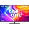 Telewizor z kolorowym, abstrakcyjnym tłem na ekranie, z widocznymi napisami: "AMBILIGHT tv", "the one", "QLED" oraz "PHILIPS". Urządzenie ma cienką ramkę i stoi na prostokątnej podstawie.