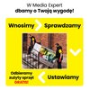 Na zdjęciu znajduje się reklama Media Expert z hasłem "W Media Expert dbamy o Twoją wygodę!" oraz napisy: "Wnosimy", "Sprawdzamy", "Ustawiamy", "Odbieramy zużyty sprzęt GRATIS!". W centralnej części widoczna jest fotografia przedstawiająca dwie osoby nios
