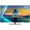 Na zdjęciu znajduje się telewizor marki PHILIPS z wyświetlonym obrazem przedstawiającym astronautę stojącego w wodzie o zachodzie słońca, z tekstem "AMBILIGHT tv OLED" na ekranie. W prawym górnym rogu widoczne jest logo "PHILIPS".