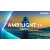 Na zdjęciu widoczny jest astronauta stojący w wodzie na tle zachodzącego słońca, z tekstem "AMBILIGHT tv OLED" na pierwszym planie. W prawym górnym rogu znajduje się logo "PHILIPS".