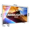 Telewizor marki PHILIPS z napisem "AMBILIGHT tv OLED" na ekranie, przedstawiający scenę z pociągiem i postaciami na tle kolorowego nieba. Wymiary telewizora to 177,3 cm szerokości, 101,3 cm wysokości, 7,9 cm głębokości, a podstawa ma 31 cm.
