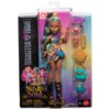 Opakowanie zawiera lalkę z serii Monster High o imieniu Nefera de Nile, ubraną w kolorowy strój z dodatkami, takimi jak złote bransoletki i turkusowa torebka. Na opakowaniu widnieje logo "Monster High" oraz napis "Nefera de Nile", a także ostrzeżenie o ma