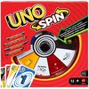 Opakowanie gry karcianej "UNO Spin" z widocznym kołem do losowania, kolorowymi kartami oraz napisami: "UNPREDICTABLE ACTION WITH EVERY SPIN!", "TRY ME! SPIN HERE!" i logo "Mattel Games". Na dole opakowania znajdują się ikony wskazujące na liczbę graczy od