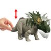 Na zdjęciu znajduje się figurka dinozaura z zielonymi i szarymi elementami, z widocznymi szczegółami na grzbiecie i głowie. Obok figurki widoczna jest ręka trzymająca ogon, a nad nią znajduje się czerwona strzałka wskazująca ruch w górę i w dół.