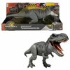 Na zdjęciu znajduje się szara figurka dinozaura T-Rex z otwartą paszczą, umieszczona w opakowaniu z logo "Jurassic World" oraz napisem "Power Devour Tyrannosaurus rex". Opakowanie zawiera również grafikę przedstawiającą dinozaura oraz logo producenta.