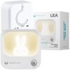 Kwadratowa lampka nocna z wizerunkiem królika, posiadająca przycisk i logo "FOREVER LIGHT" na obudowie, znajduje się obok pudełka z napisem "LEA LED NIGHT LIGHT WITH MOTION SENSOR" oraz "LED'S LIGHT THE WAY".