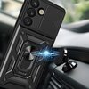 Czarne etui na telefon z trzema widocznymi obiektywami aparatu i przesuwaną osłoną kamery, zamontowane na magnetycznym uchwycie w samochodzie. Wokół uchwytu widoczne są niebieskie efekty świetlne przypominające błyskawice.