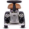 Czarny jeździk w stylu retro z brązowym siedzeniem, posiadający srebrny grill z napisem "CLASSIC" oraz dwa okrągłe reflektory. Kierownica jest czarna, a zderzak i detale są chromowane.