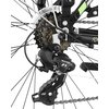 Zbliżenie na mechanizm tylnej przerzutki roweru z widocznymi zębatkami i łańcuchem. Na przerzutce widoczny jest napis "Tourney" oraz "Shimano".