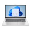 Srebrny laptop z dużym ekranem, na którym wyświetlony jest pulpit systemu Windows 11 z otwartym menu Start. Na obudowie widoczne jest logo producenta.