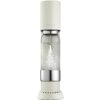 Beżowy saturator do wody z przezroczystą butelką, w której widoczne są bąbelki gazowanej wody. Na urządzeniu znajduje się logo "sodastream".