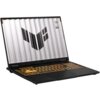 Laptop z otwartym ekranem, na którym widoczne jest logo w kształcie litery "V" oraz napisy "TUF" i "STAY TUF". Klawiatura jest podświetlona na pomarańczowo.