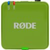 Zielony, kwadratowy moduł z logo "RØDE" na środku, z widocznymi oznaczeniami "REC" i symbolem łańcucha w górnym rogu. Na górze znajdują się dwa przyciski: niebieski i czerwony.