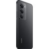 Czarny smartfon z trzema obiektywami aparatu i napisem "REDMI" na dolnej części obudowy. Na module aparatu widoczny jest napis "AI TRIPLE CAMERA".