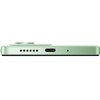 Zbliżenie na dolną krawędź zielonego smartfona, na której widoczne są otwory głośnika, port USB-C oraz mały otwór prawdopodobnie na mikrofon. Na górze zdjęcia widać lekko wystający moduł aparatu.