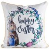 Biała poszewka z nadrukiem przedstawiającym królika trzymającego niebieskie jajko, otoczonego wieńcem z kwiatów i liści, z napisem "happy Easter". Krawędzie poszewki są obszyte złotą lamówką.