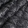 Czarna narzuta z geometrycznym wzorem w odcieniach szarości, o fakturze pikowanej, ukazana w zbliżeniu. Produkt to "Narzuta EUROFIRANY Blink 6 170 x 210 cm Czarny".