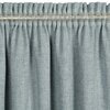 Jasnoniebieska zasłona o fakturze przypominającej len, z marszczeniami na górze, zawieszona na przezroczystej taśmie. Produkt to "Zasłona EUROFIRANY Jula2 140 x 270 cm Jasnoniebieski".
