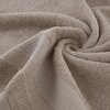 Beżowy ręcznik o wymiarach 30 x 50 cm jest ułożony w spiralny wzór, ukazując swoją teksturę i delikatne wykończenie. Materiał ręcznika jest miękki i puszysty, z widocznymi detalami tkaniny.
