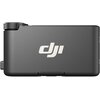 Czarny odbiornik z logo "dji" na środku obudowy, z widocznym pokrętłem na górze. Obudowa ma matowe wykończenie.