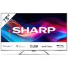 Na zdjęciu widoczny jest telewizor z dużym ekranem, na którym wyświetlone jest logo "SHARP" na tle kolorowych fal. Na dolnym pasku znajdują się ikony i napisy: "Google TV", "High Brightness", "QLED", "Sound by harman/kardon", "Dolby Vision Atmos".